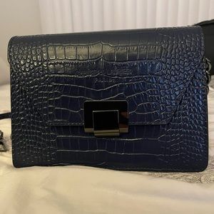 Navy purse with shoulder or crossbody straps.